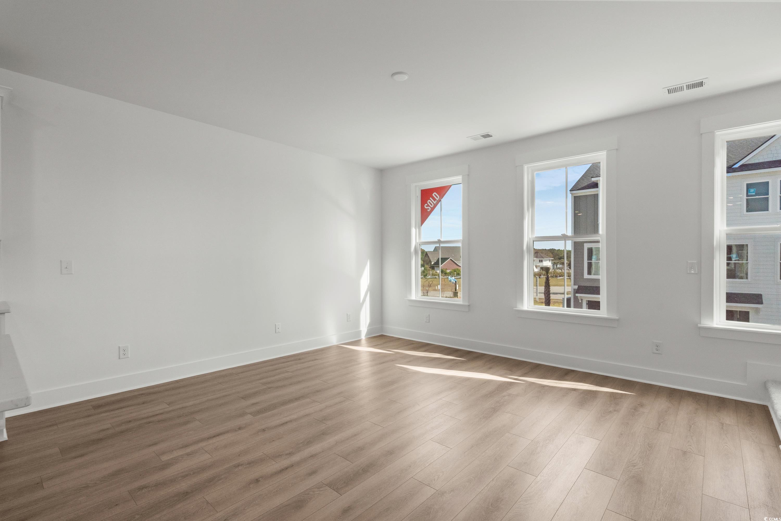 4414 Kingsport Road, Unit 1402 Little River, SC 29566 - Photo 11 of 34 Empty room featuring wood finished floors and baseboards