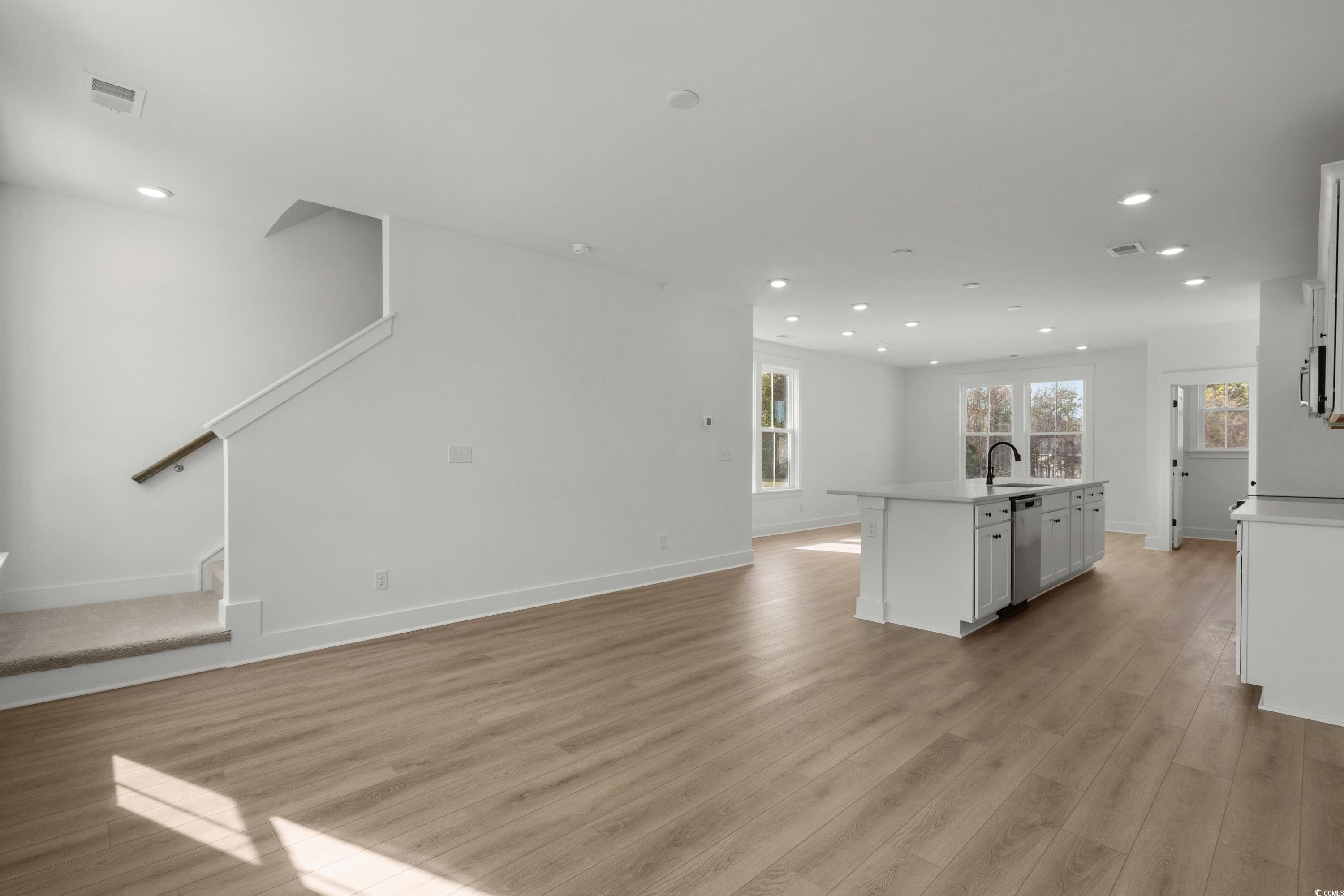 4414 Kingsport Road, Unit 1402 Little River, SC 29566 - Photo 12 of 34 Unfurnished living room featuring recessed lighting, light wood-style flooring, and stairway