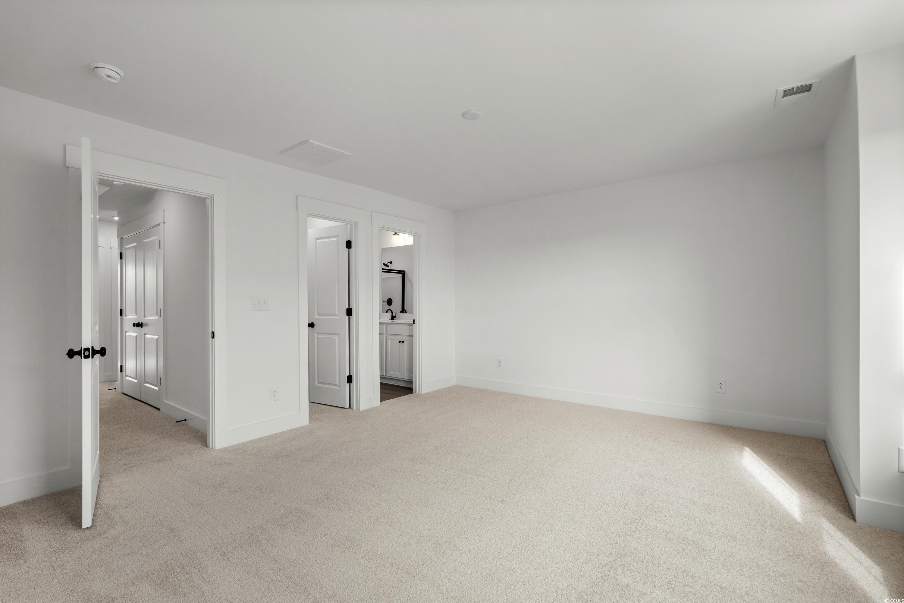 4414 Kingsport Road, Unit 1402 Little River, SC 29566 - Photo 15 of 34 Unfurnished bedroom featuring light carpet and connected bathroom