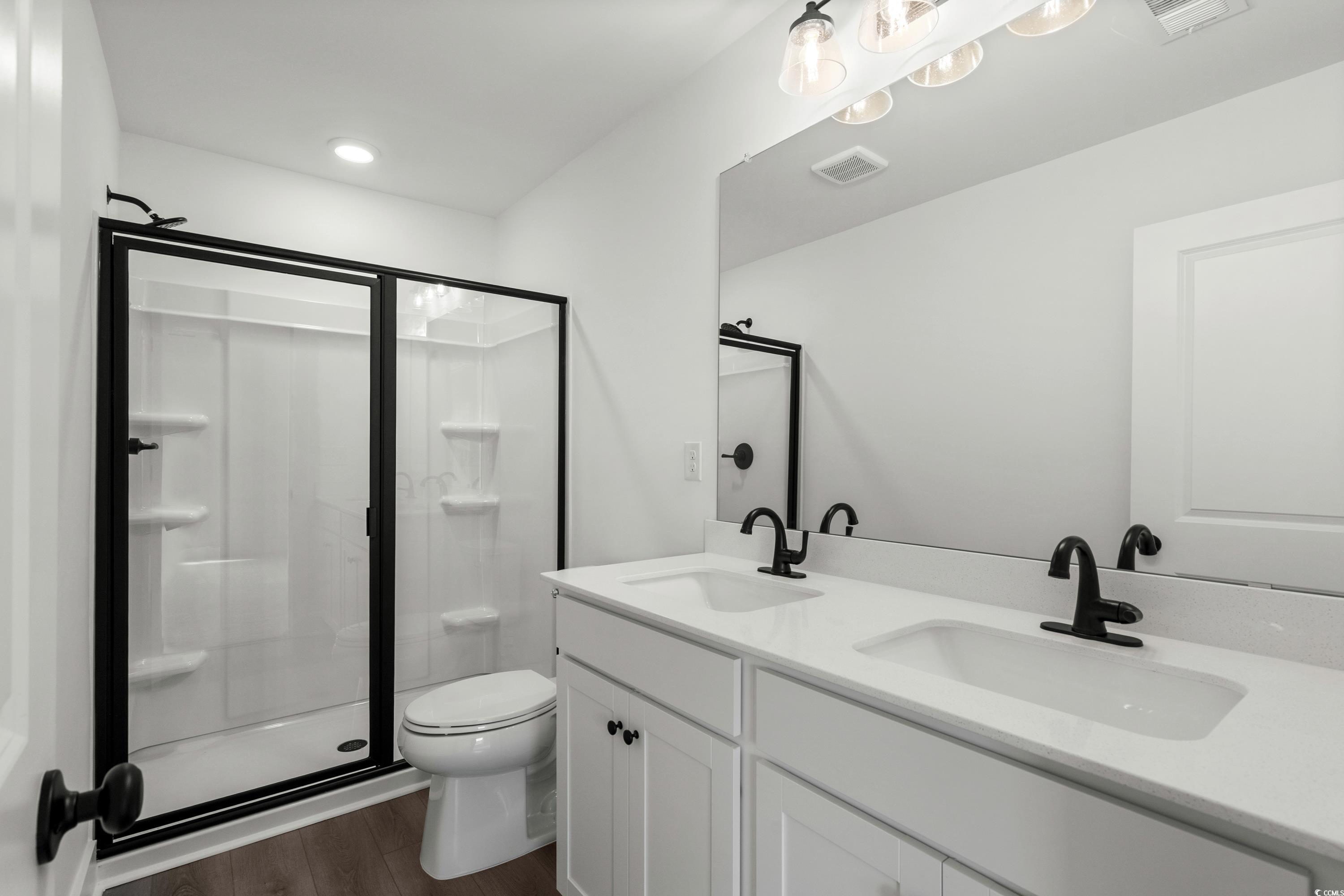 4414 Kingsport Road, Unit 1402 Little River, SC 29566 - Photo 16 of 34 Full bath featuring dark wood-style floors, double vanity, and a shower stall