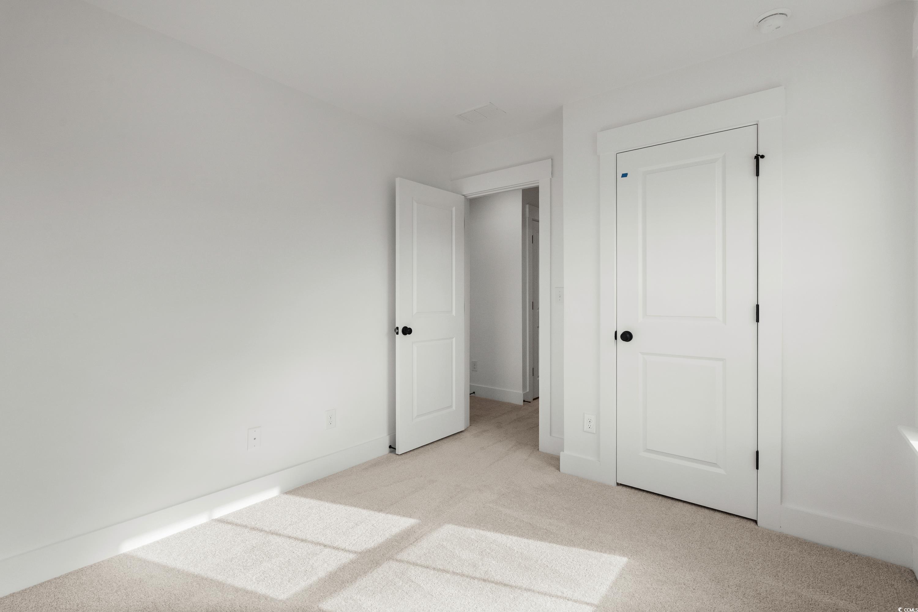 4414 Kingsport Road, Unit 1402 Little River, SC 29566 - Photo 18 of 34 Unfurnished bedroom featuring light colored carpet and baseboards