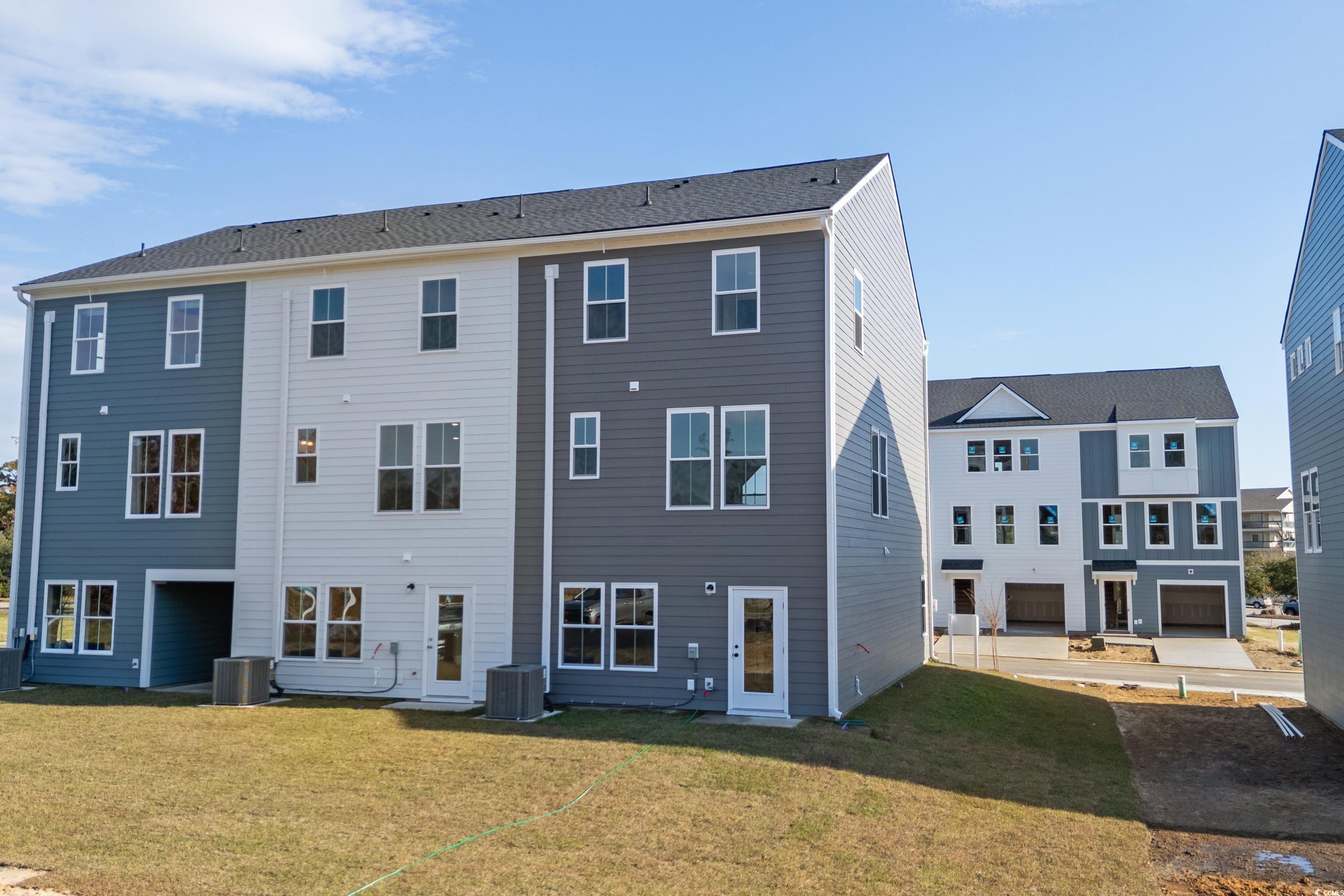 4414 Kingsport Road, Unit 1402 Little River, SC 29566 - Photo 2 of 34 Rear view of house featuring a lawn