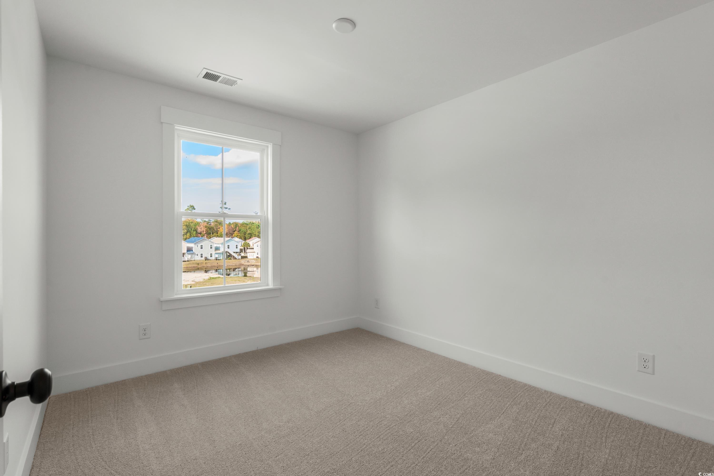 4414 Kingsport Road, Unit 1402 Little River, SC 29566 - Photo 19 of 34 Unfurnished room with baseboards and light carpet
