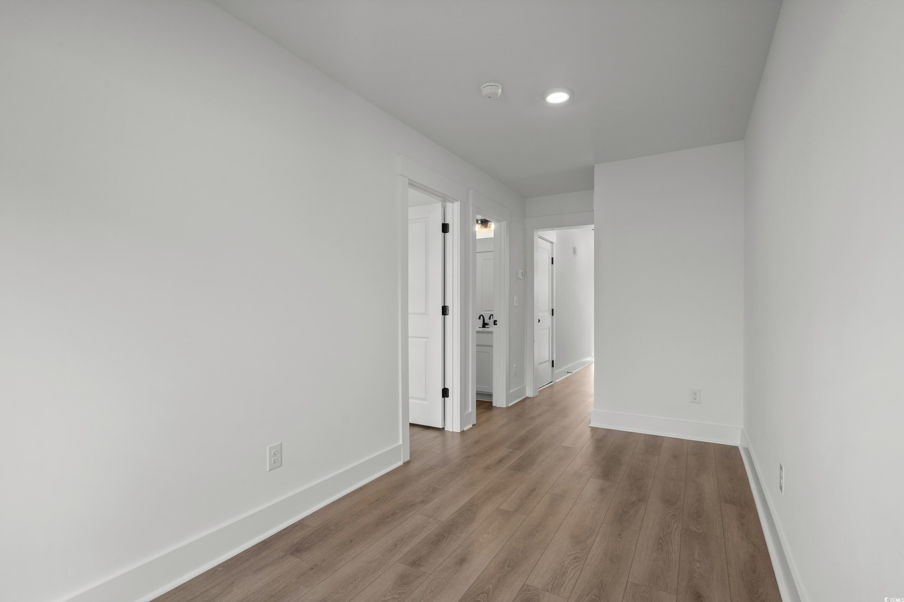 4414 Kingsport Road, Unit 1402 Little River, SC 29566 - Photo 23 of 34 Empty room featuring wood finished floors and recessed lighting