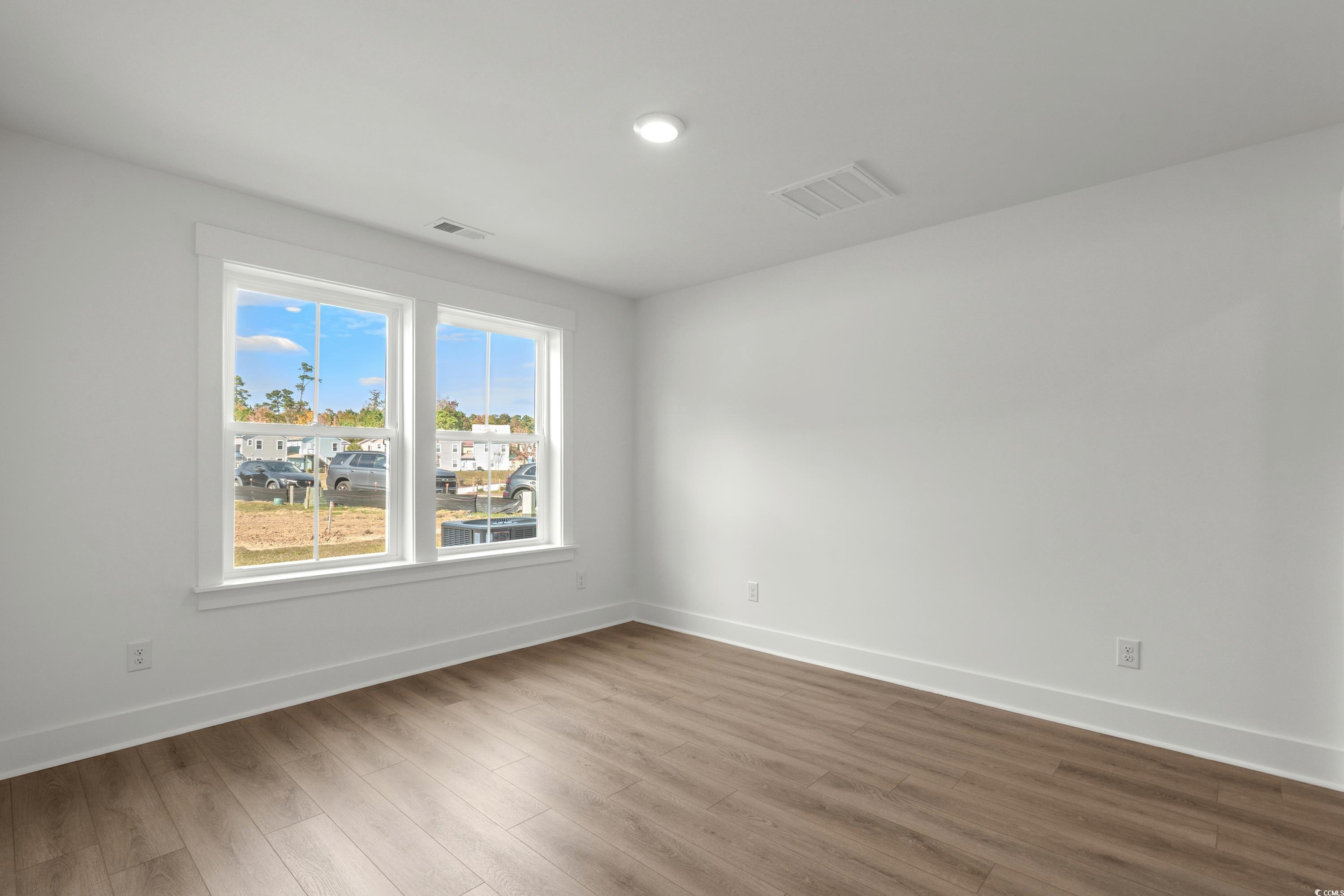4414 Kingsport Road, Unit 1402 Little River, SC 29566 - Photo 24 of 34 Empty room featuring baseboards and wood finished floors