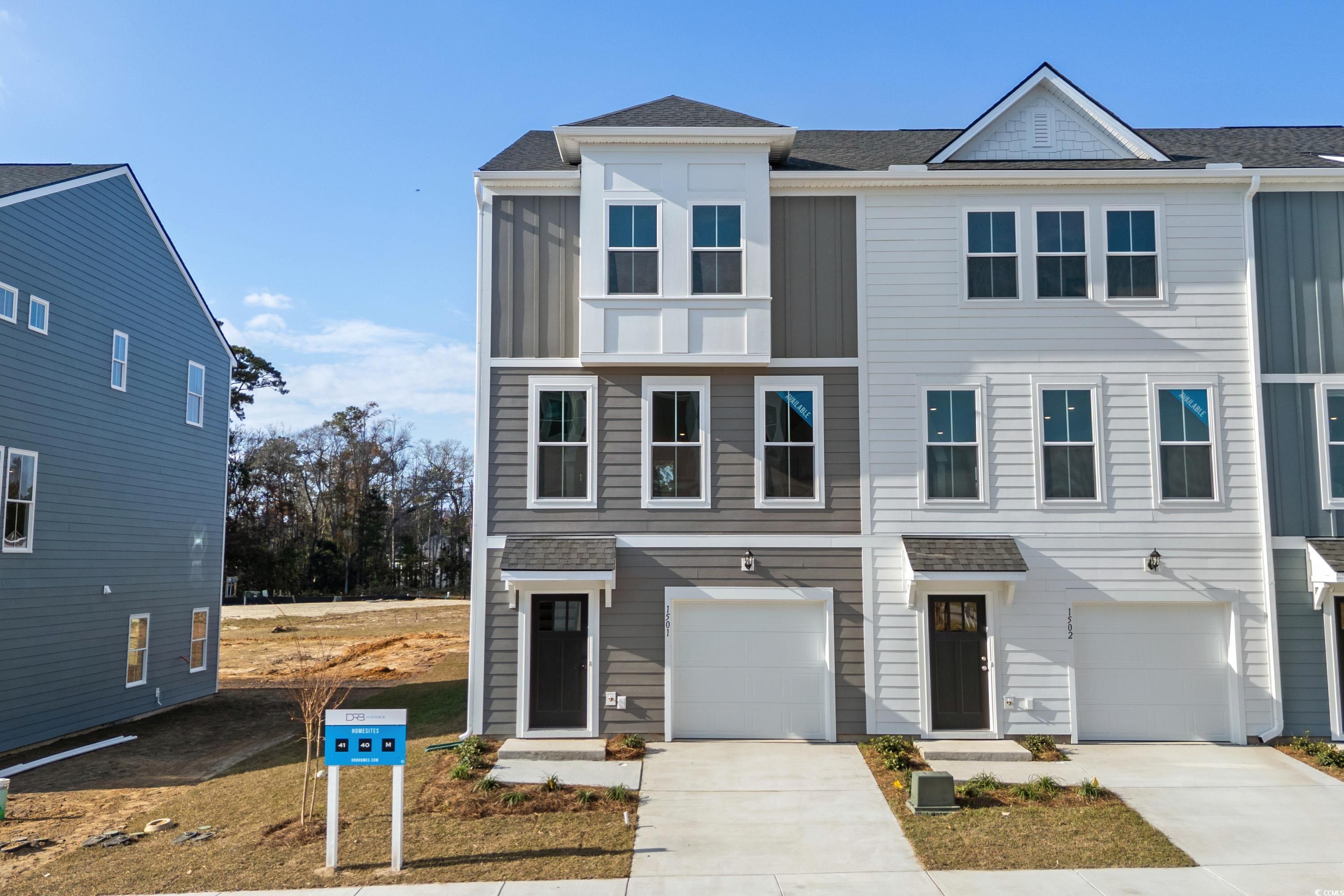 4414 Kingsport Road, Unit 1402 Little River, SC 29566 - Photo 3 of 34 View of front facade with roof with shingles, driveway, and an attached garage