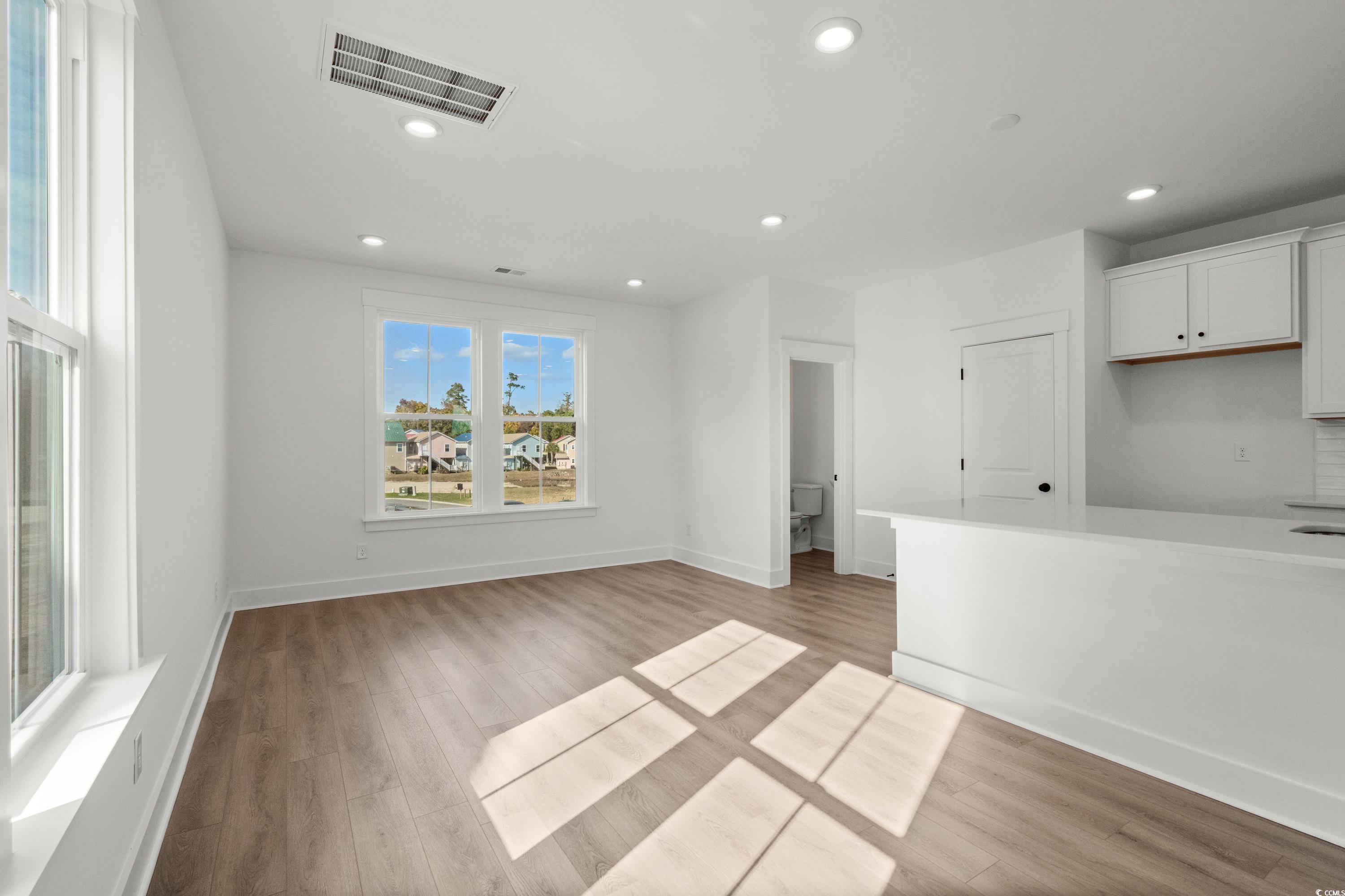 4414 Kingsport Road, Unit 1402 Little River, SC 29566 - Photo 5 of 34 Unfurnished living room with light wood-type flooring and recessed lighting