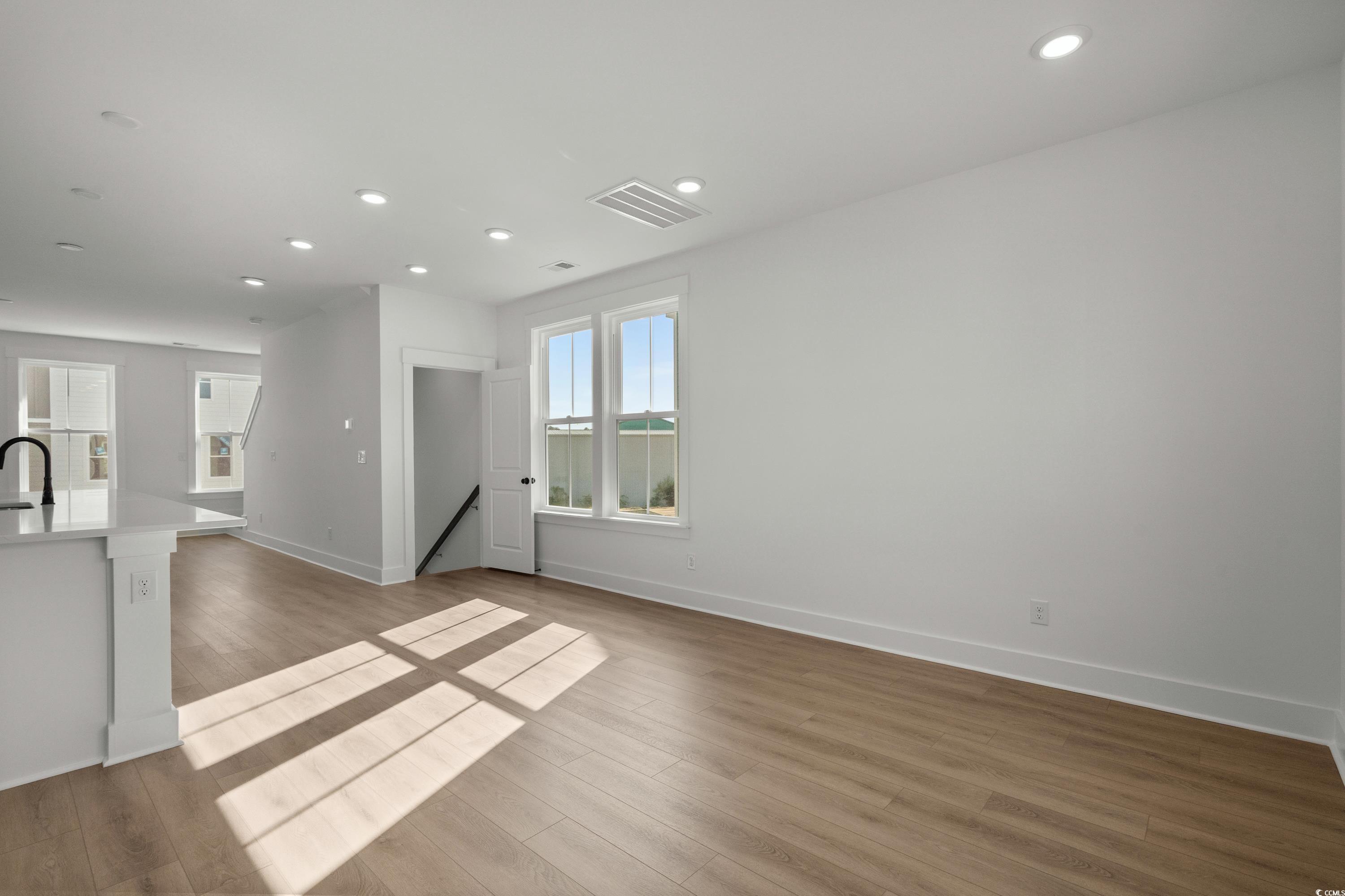 4414 Kingsport Road, Unit 1402 Little River, SC 29566 - Photo 6 of 34 Unfurnished living room with light wood finished floors and recessed lighting