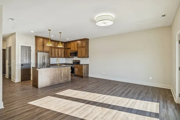 a view of kitchen with wooden floor and electronic appliances