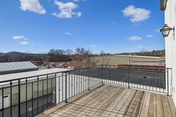 a view of balcony with wooden floor and city view