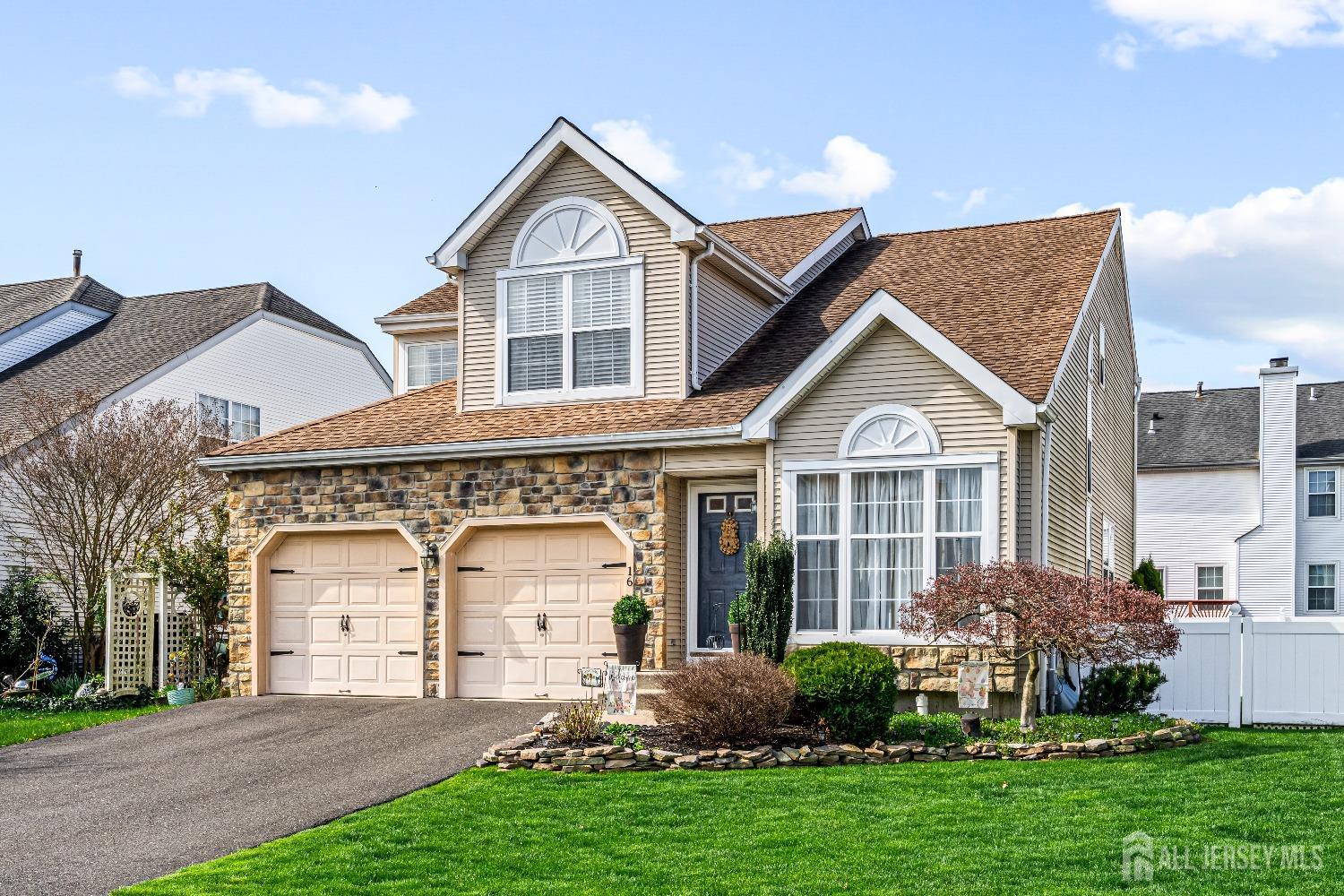 16 Dryden Drive Burlington, NJ 08016 - Photo 3 of 13 a front view of a house with a yard and garage