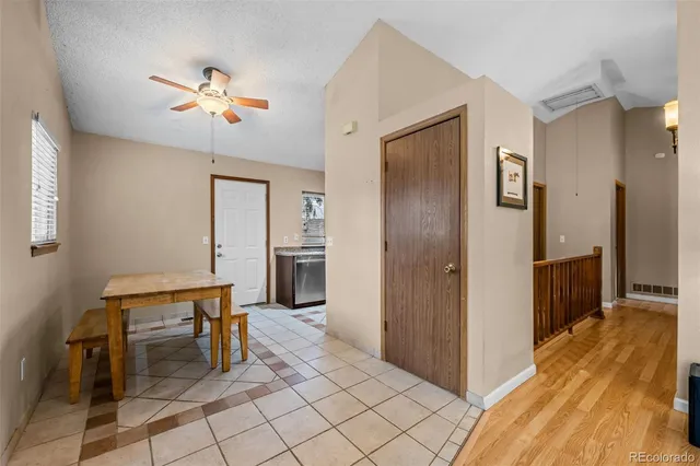 a view of a hallway with chairs and closet area