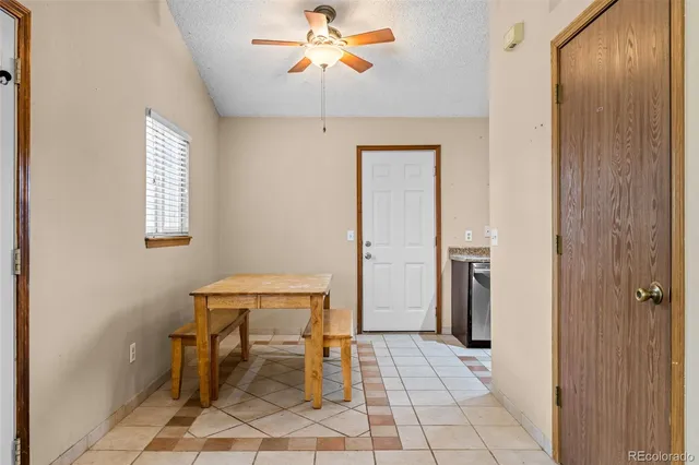 a room with furniture and a chandelier fan
