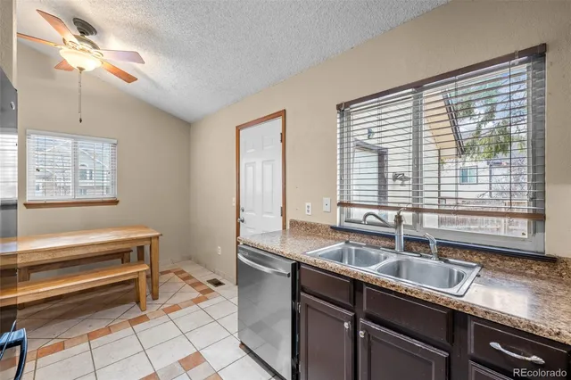 a kitchen with a sink and large window
