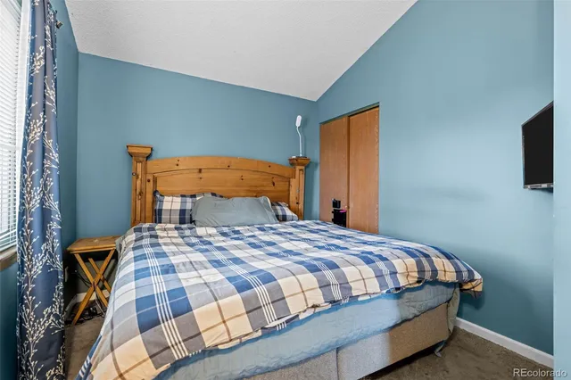 a bedroom with a bed and flat screen tv