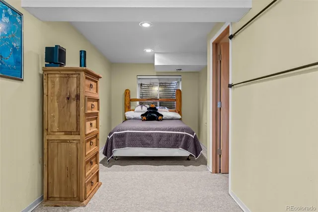 a bed room with a bed and a refrigerator