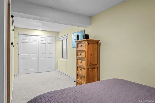 a bedroom with a bed and cabinets