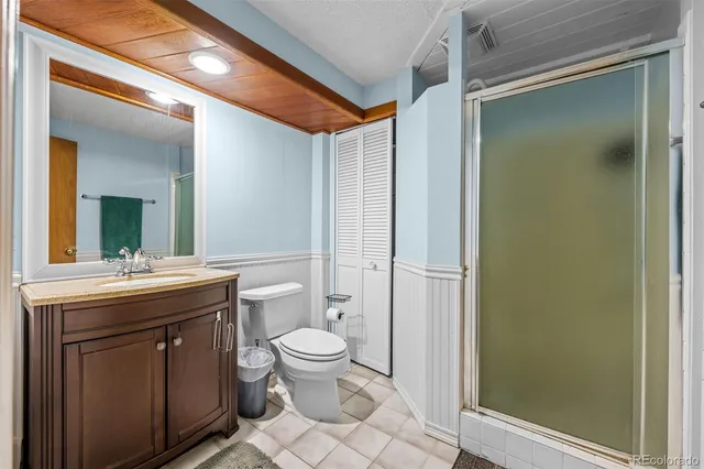 a spacious bathroom with a granite countertop sink toilet and shower
