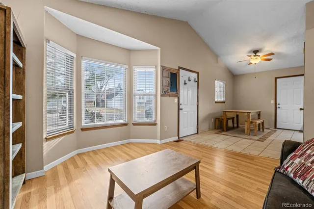 a spacious bedroom with a bed and a chandelier
