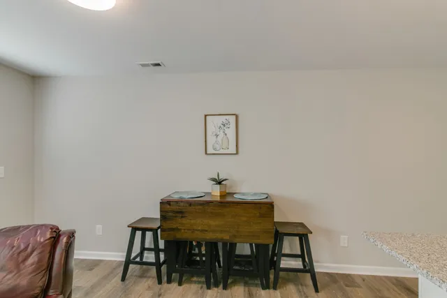 a dining room with a table and chairs