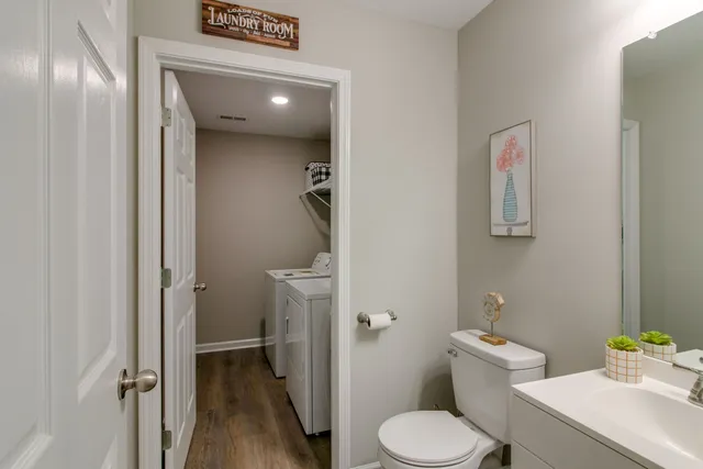 a white toilet sitting next to a bathroom sink