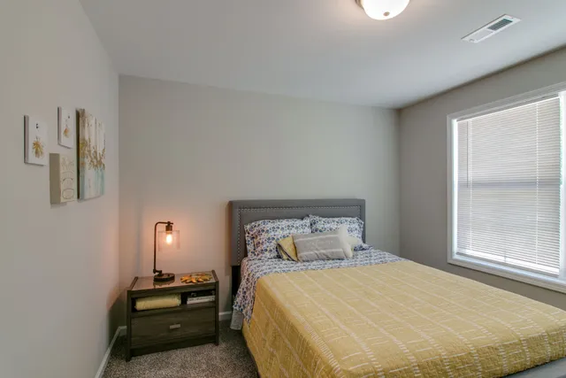 a bedroom with a bed and a window