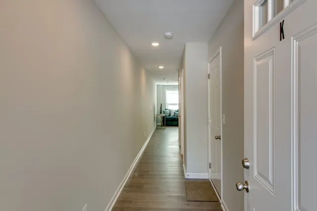 a view of hallway with wooden floor