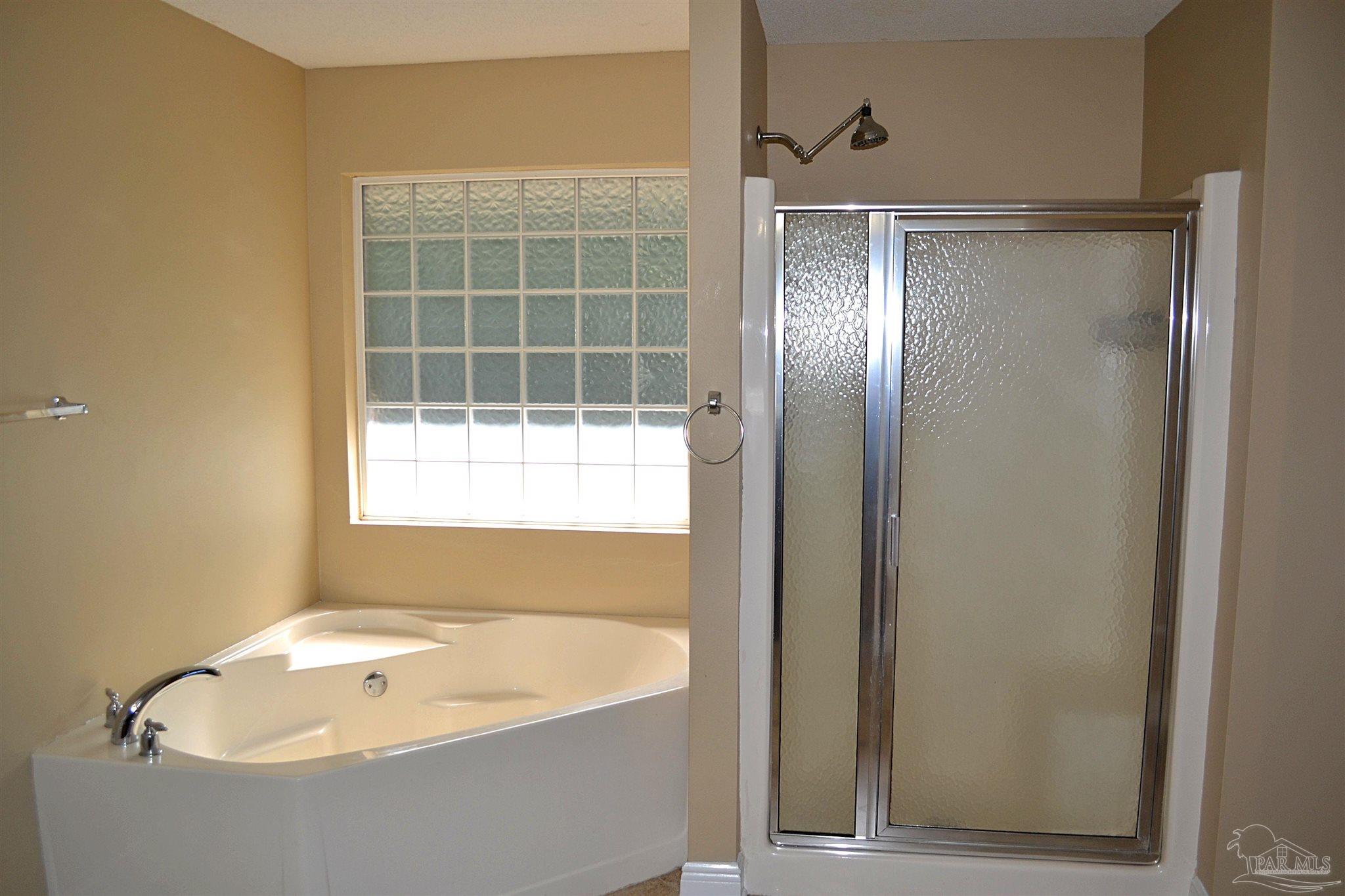 3055 Wallace Lake Road Pace, FL 32571 - Photo 28 of 33 a bathroom with a bathtub and a shower