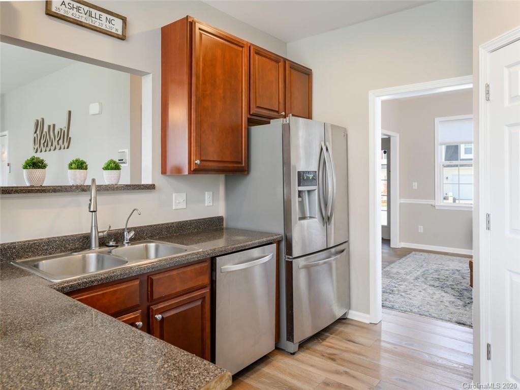 121 Haw River Road Fletcher, NC 28732 - Photo 13 of 42 a kitchen with stainless steel appliances granite countertop a refrigerator and a sink