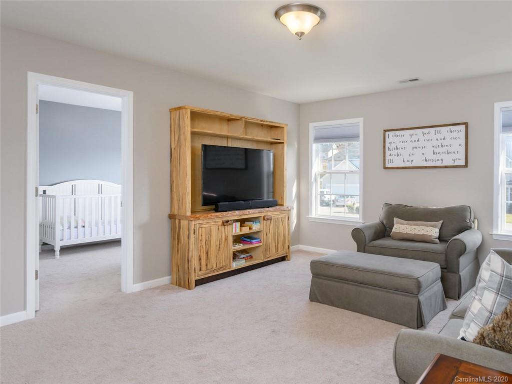 121 Haw River Road Fletcher, NC 28732 - Photo 17 of 42 a living room with furniture and a flat screen tv