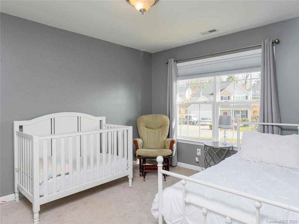 121 Haw River Road Fletcher, NC 28732 - Photo 19 of 42 a bed room with a bed and a chair