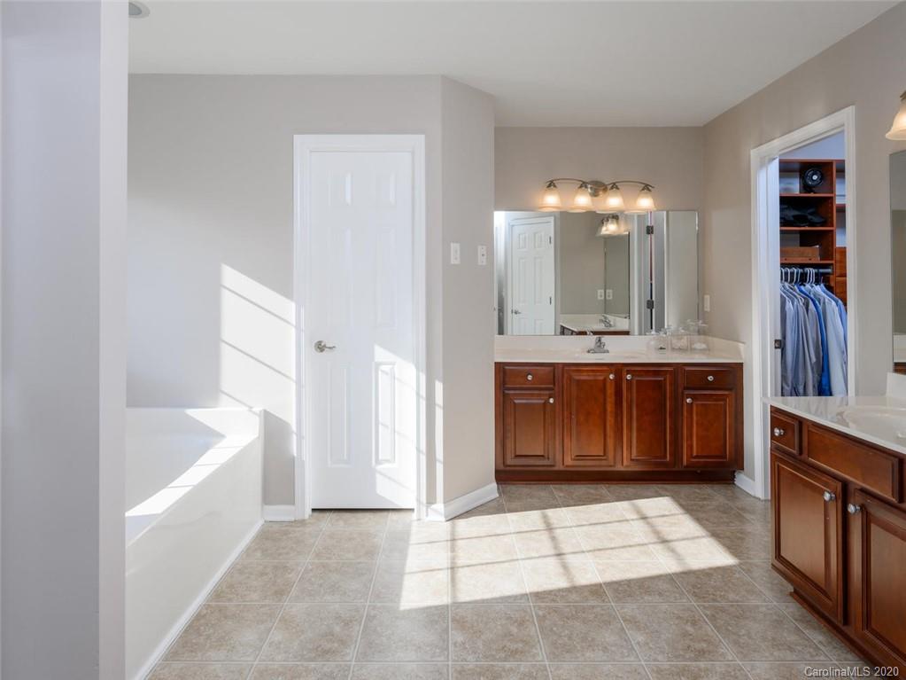 121 Haw River Road Fletcher, NC 28732 - Photo 23 of 42 a spacious bathroom with a tub sink and mirror