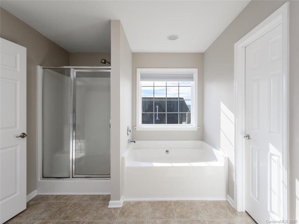 121 Haw River Road Fletcher, NC 28732 - Photo 24 of 42 a white bath tub sitting in a bathroom