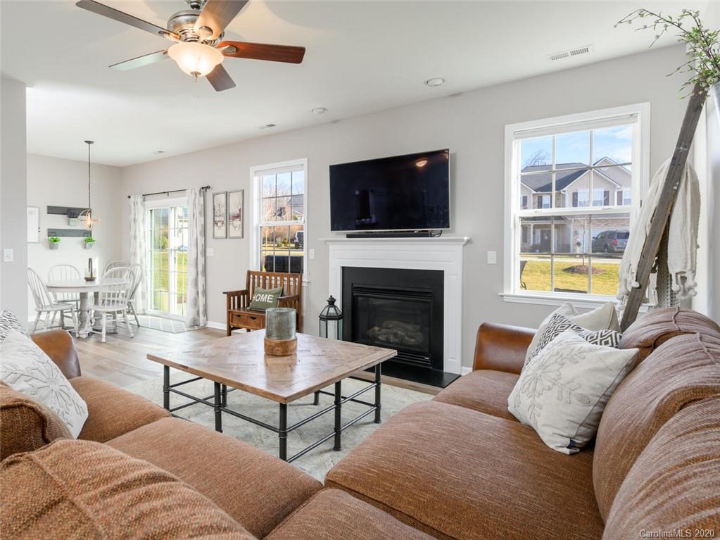 121 Haw River Road Fletcher, NC 28732 - Photo 9 of 42 a living room with furniture a flat screen tv and a fireplace