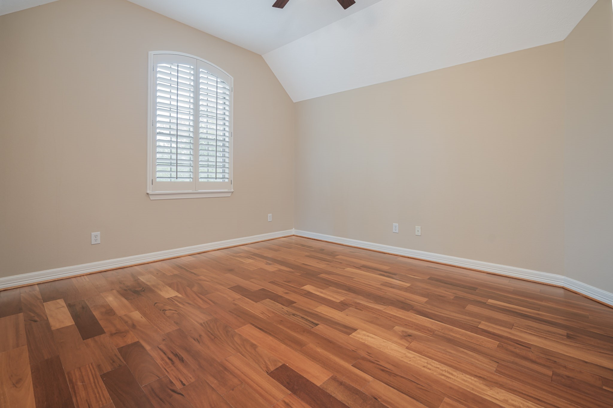 6506 Monte Bello Ridge Lane Houston, TX 77041 - Photo 22 of 39 This inviting bedroom, BR #4, features elegant hardwood floors, a soothing neutral palette, and a bright window with shutters, offering both comfort and style for a serene retreat.