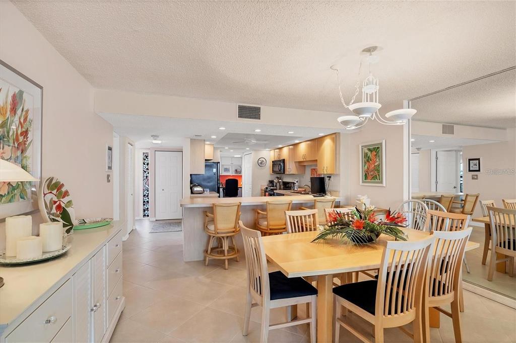 6480 Midnight Pass Road, Unit 506 Sarasota, FL 34242 - Photo 11 of 49 a view of a dining room with furniture and wooden floor