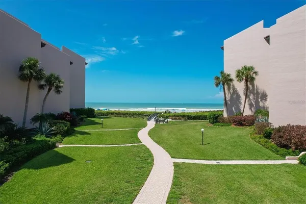 a view of pool with outdoor seating and plants