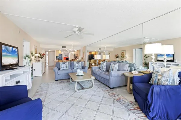 a kitchen with stainless steel appliances kitchen island granite countertop a refrigerator and microwave