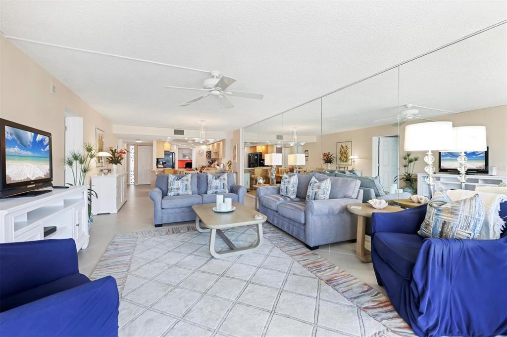 6480 Midnight Pass Road, Unit 506 Sarasota, FL 34242 - Photo 28 of 49 a living room with furniture and a flat screen tv