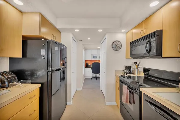 a kitchen with stainless steel appliances granite countertop a stove top oven a sink dishwasher and cabinets with wooden floor