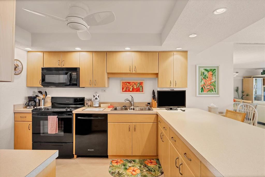 6480 Midnight Pass Road, Unit 506 Sarasota, FL 34242 - Photo 32 of 49 a kitchen with a sink a stove and refrigerator