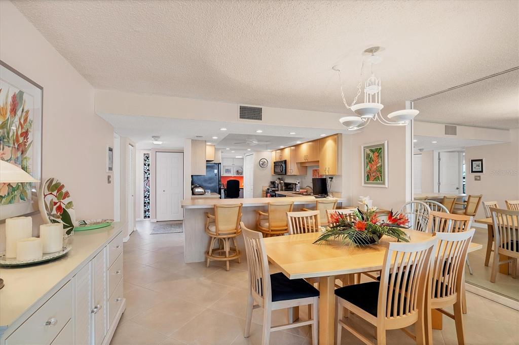 6480 Midnight Pass Road, Unit 506 Sarasota, FL 34242 - Photo 34 of 49 a view of a dining room with furniture and wooden floor
