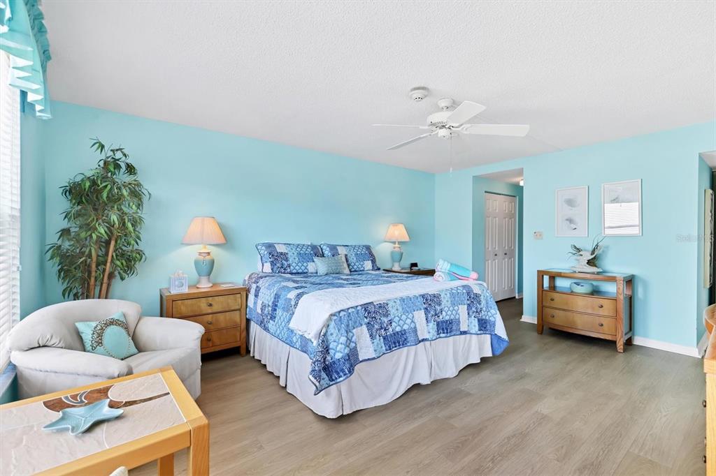 6480 Midnight Pass Road, Unit 506 Sarasota, FL 34242 - Photo 39 of 49 a bedroom with bed and a chandelier