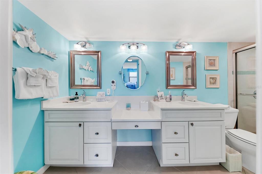 6480 Midnight Pass Road, Unit 506 Sarasota, FL 34242 - Photo 40 of 49 a bathroom with a double vanity sink and a mirror
