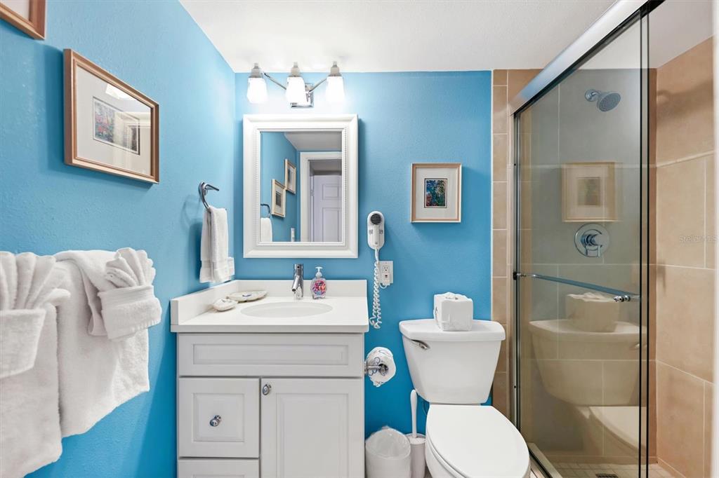 6480 Midnight Pass Road, Unit 506 Sarasota, FL 34242 - Photo 42 of 49 a bathroom with a toilet sink and mirror