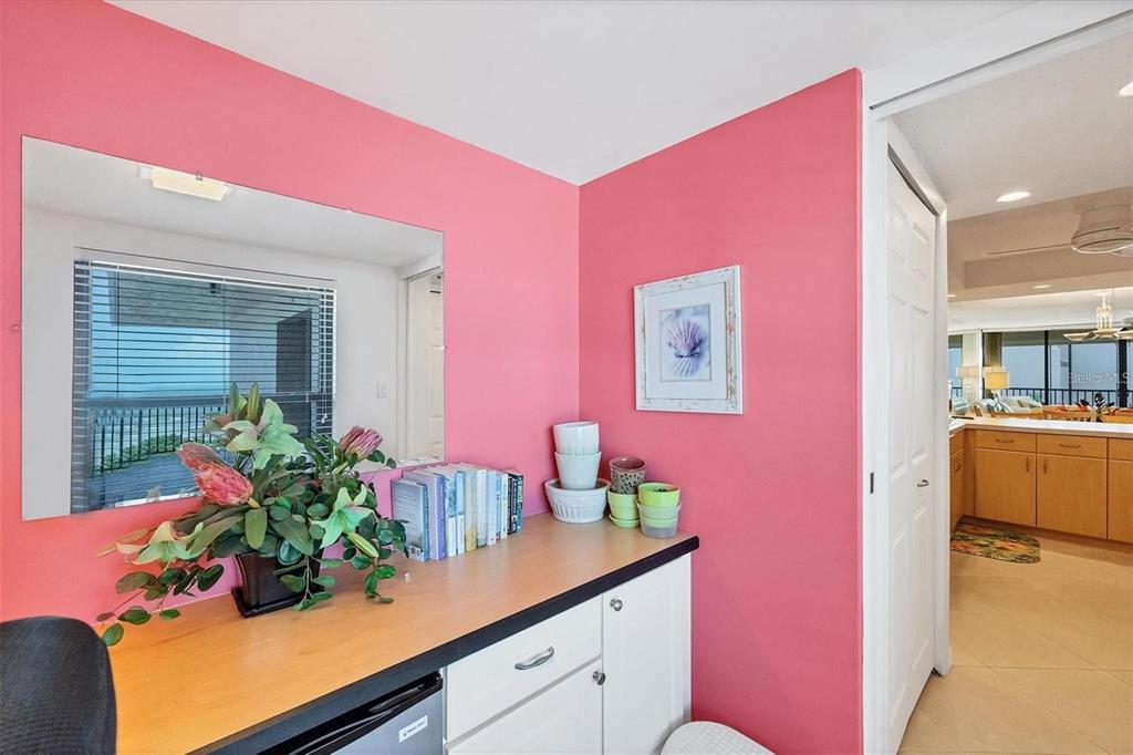6480 Midnight Pass Road, Unit 506 Sarasota, FL 34242 - Photo 43 of 49 a kitchen with a potted plant on the counter and cabinets