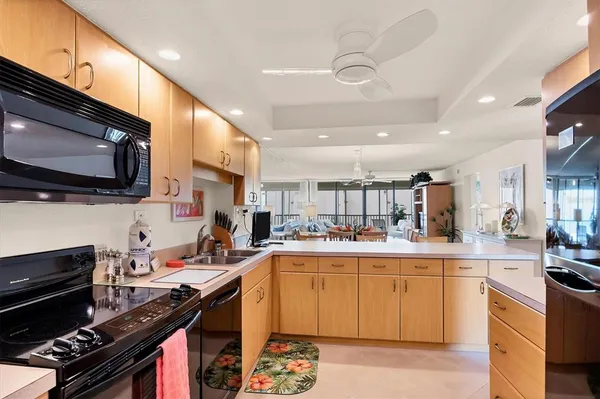 a kitchen with a sink a stove and cabinets