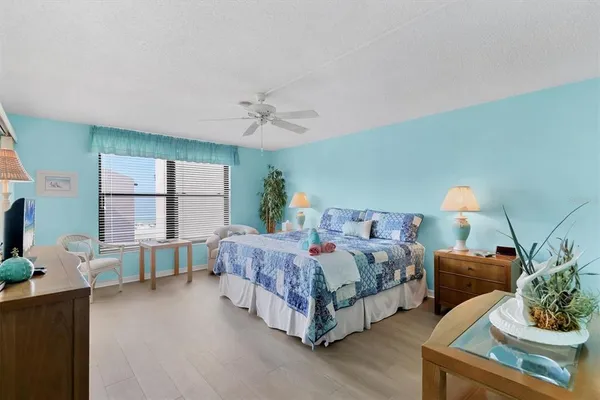 a spacious bedroom with a bed and large windows