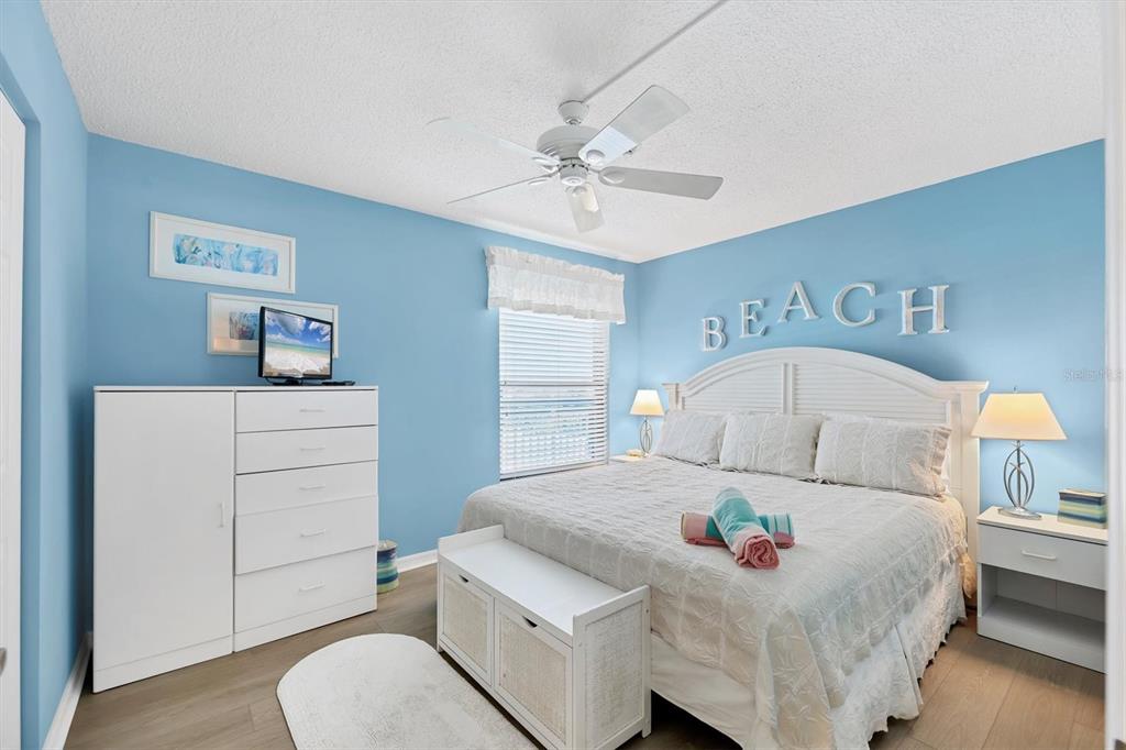 6480 Midnight Pass Road, Unit 506 Sarasota, FL 34242 - Photo 7 of 49 a bedroom with a bed and a dresser