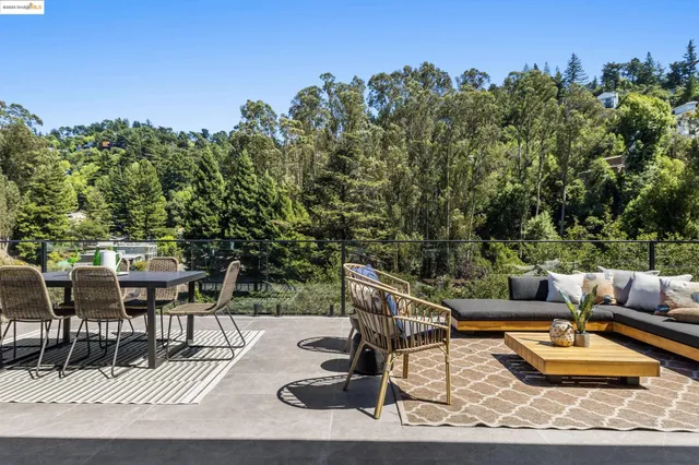 a kitchen with stainless steel appliances kitchen island granite countertop a table and chairs in it